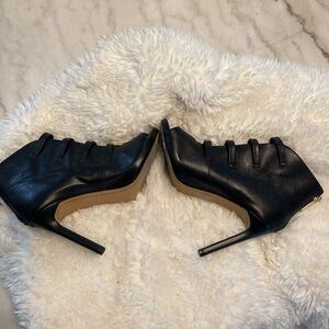 Karl Lagerfeld black leather open toe booties.
